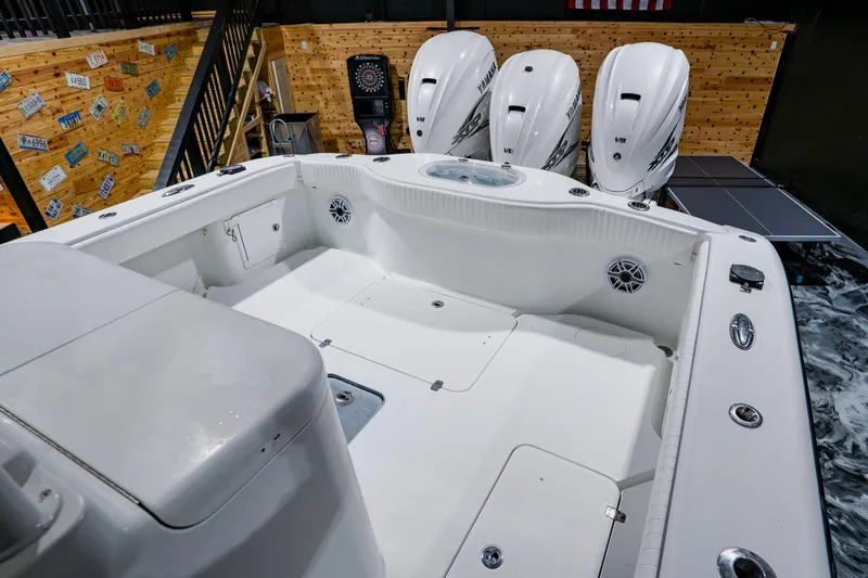 Slide: The Image of 2012 Yellowfin 39 Offshore boat with Yamaha V8 engines in a wooden interior setting. - 30