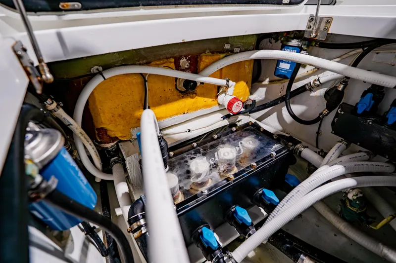 Slide: The Image of Engine compartment of a 2012 Yellowfin 39 Offshore boat, showcasing hoses and components. - 38