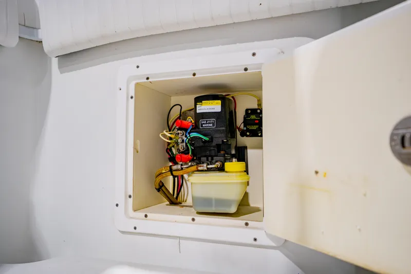 Slide: The Image of 2012 Yellowfin 39 Offshore boat compartment with marine equipment and wiring. - 40