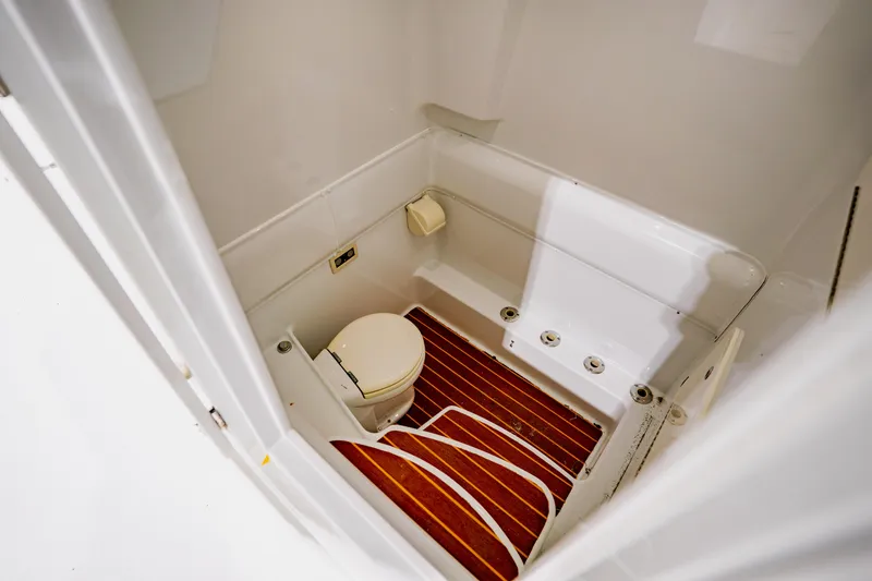 Slide: The Image of 2012 Yellowfin 39 Offshore boat bathroom with wooden flooring and compact toilet. - 41