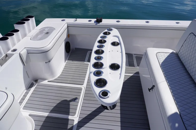 Slide: The Image of 2019 SeaHunter 45 Tournament boat interior with rod holders and cushioned seating. - 15