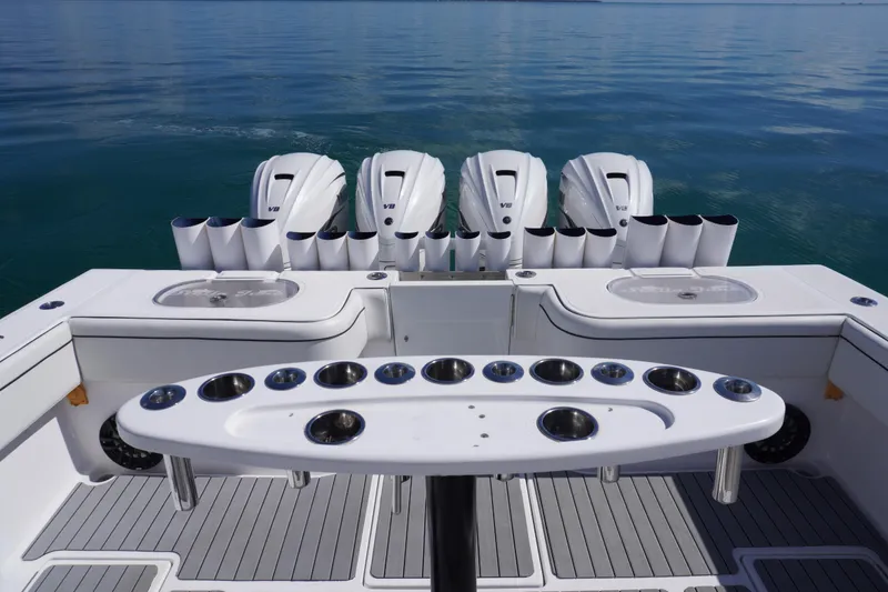 Slide: The Image of 2019 SeaHunter 45 Tournament boat with multiple outboard engines on calm water. - 17