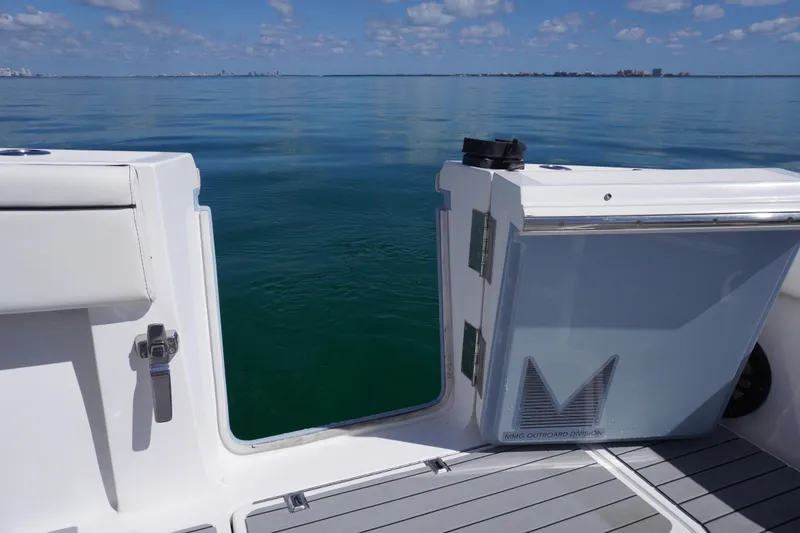 Slide: The Image of 2019 SeaHunter 45 Tournament boat with open side door, calm ocean view. - 19