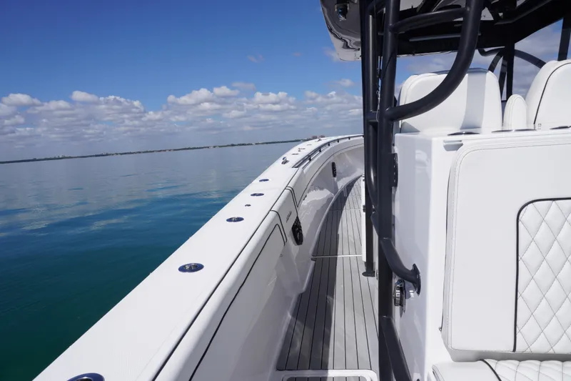 Slide: The Image of 2019 SeaHunter 45 Tournament boat on calm water under a clear blue sky. - 22