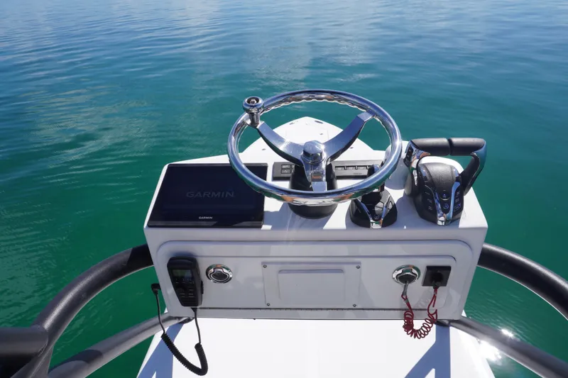 Slide: The Image of 2019 SeaHunter 45 Tournament helm with Garmin display and controls on calm water. - 29