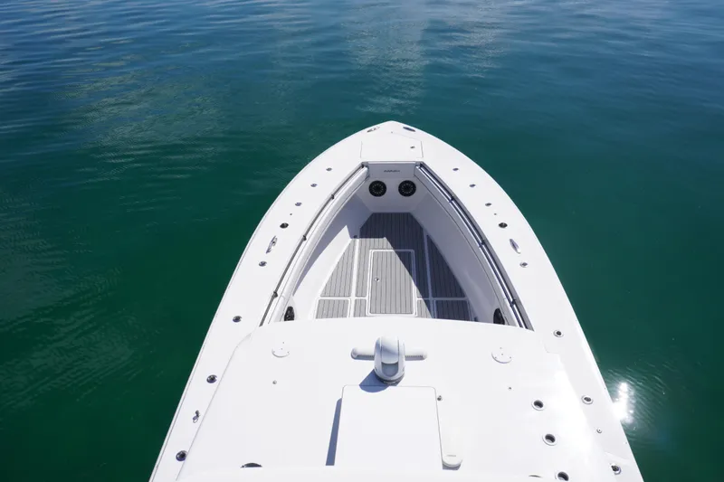 Slide: The Image of 2019 SeaHunter 45 Tournament boat on calm water, showcasing sleek design and spacious deck. - 30