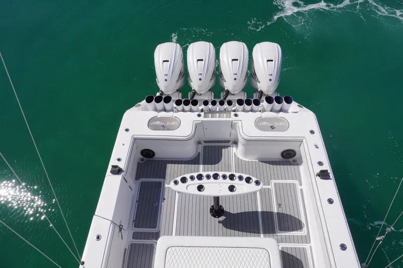 Slide: The Image of 2019 SeaHunter 45 Tournament boat with four powerful outboard engines on turquoise water. - 31