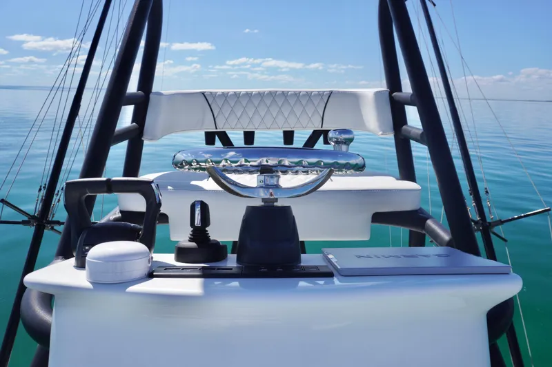 Slide: The Image of 2019 SeaHunter 45 Tournament helm with steering wheel and navigation equipment on calm water. - 33