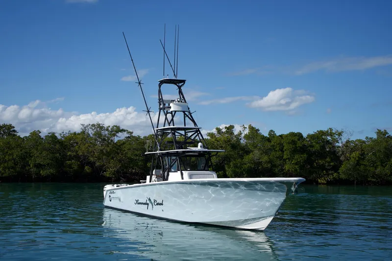 Slide: The Image of 2019 SeaHunter 45 Tournament boat on calm water with lush green background. - 6