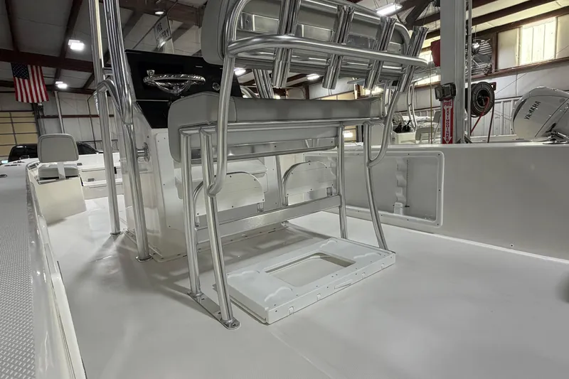 Slide: The Image of 2026 Bay Rider 2460 FS Skiff boat interior with cushioned seating and cup holders. - 11