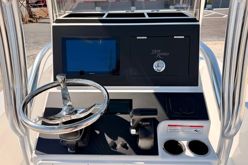 Slide: The Image of 2026 Bay Rider 2460 FS Skiff console with steering wheel and navigation display. - 27