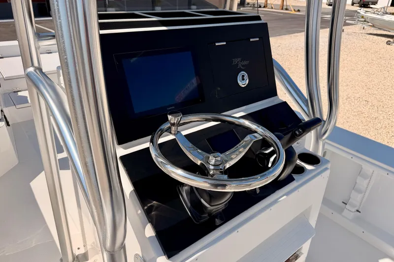 Slide: The Image of 2026 Bay Rider 2460 FS Skiff helm with steering wheel and control panel. - 28