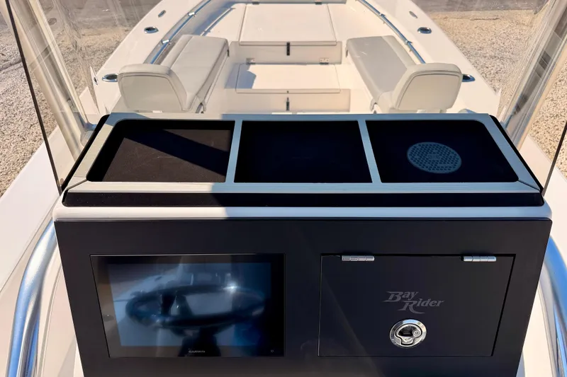 Slide: The Image of Bay Rider 2460 FS Skiff 2026 console with seating and navigation display. - 29