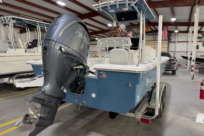 Slide: The Image of 2026 Bay Rider 2460 FS Skiff on trailer, displayed outdoors under clear sky. - 3