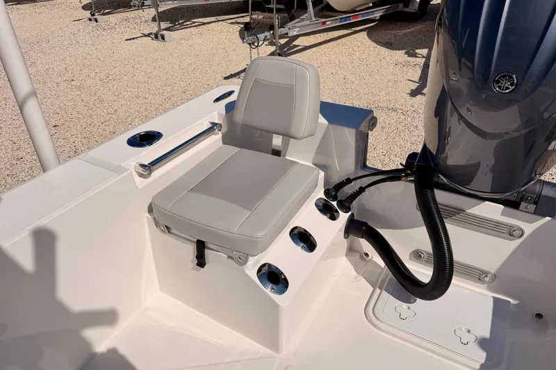 Slide: The Image of Bay Rider 2460 FS Skiff 2026 boat seat and motor detail in sunlight. - 34
