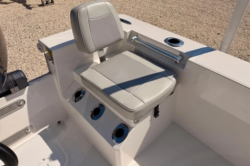 Slide: The Image of 2026 Bay Rider 2460 FS Skiff boat seat with rod holders and grab rail. - 35