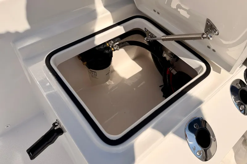 Slide: The Image of 2026 Bay Rider 2460 FS Skiff storage compartment with open hatch and visible components. - 37
