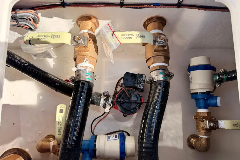 Slide: The Image of 2026 Bay Rider 2460 FS Skiff plumbing system with valves and hoses. - 38