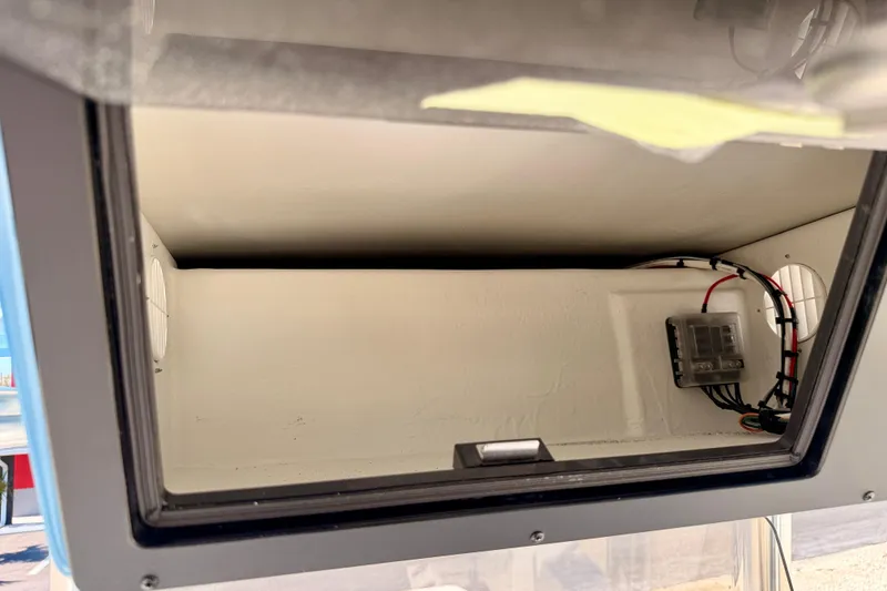 Slide: The Image of Storage compartment of 2026 Bay Rider 2460 FS Skiff with wiring and panel. - 43