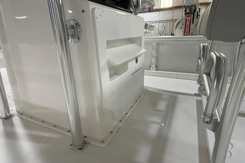 Slide: The Image of 2026 Bay Rider 2460 FS Skiff with powerful outboard motor, parked on gravel. - 6