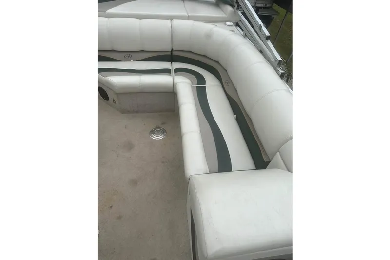 Slide: The Image of 2006 Avalon Paradise 24' boat interior with white and gray seating. - 6