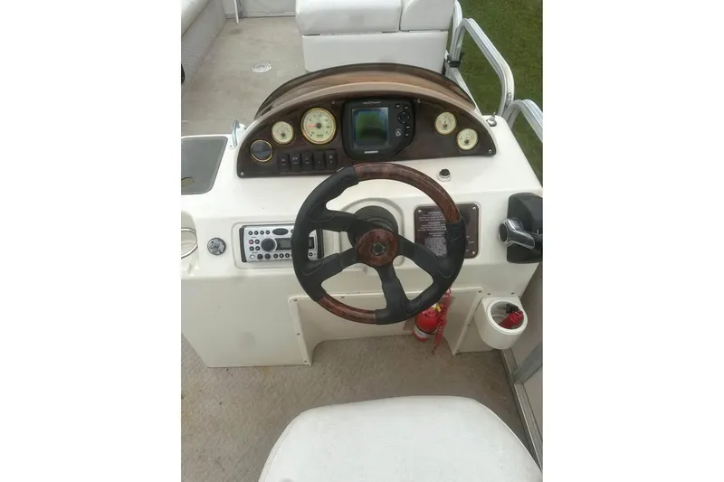 Slide: The Image of Steering console of 2006 Avalon Paradise 24' boat with gauges and controls. - 7