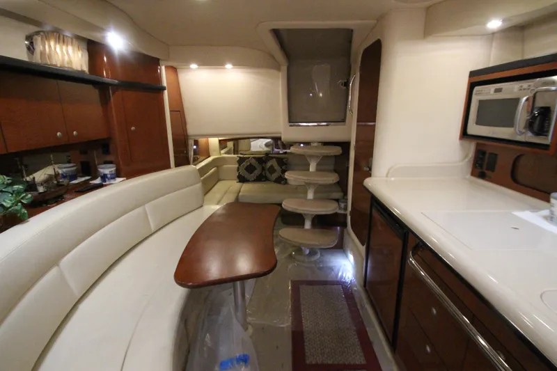 Slide: The Image of Interior of 2005 Sea Ray 340 Sundancer yacht with modern kitchen and seating area. - 14
