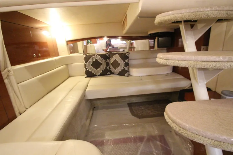 Slide: The Image of Interior of 2005 Sea Ray 340 Sundancer with beige seating and decorative pillows. - 17