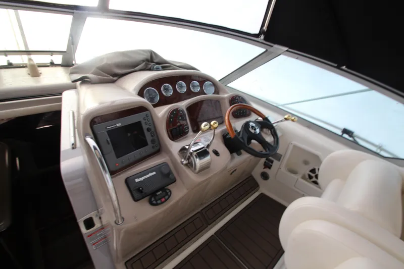 Slide: The Image of 2005 Sea Ray 340 Sundancer helm with gauges, steering wheel, and navigation equipment. - 24