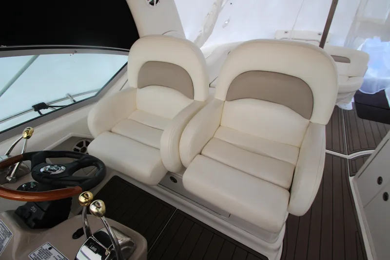 Slide: The Image of Captain's chairs and helm of 2005 Sea Ray 340 Sundancer yacht interior. - 26
