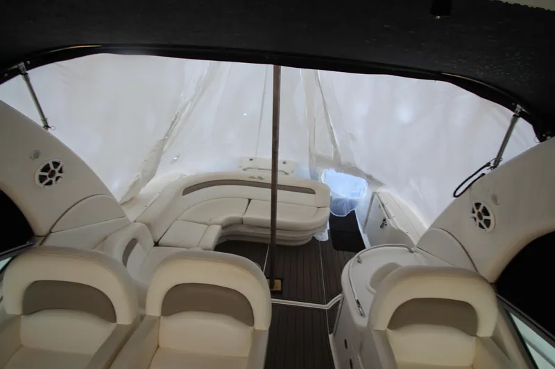 Slide: The Image of Interior of 2005 Sea Ray 340 Sundancer boat with white seating and wood flooring. - 28