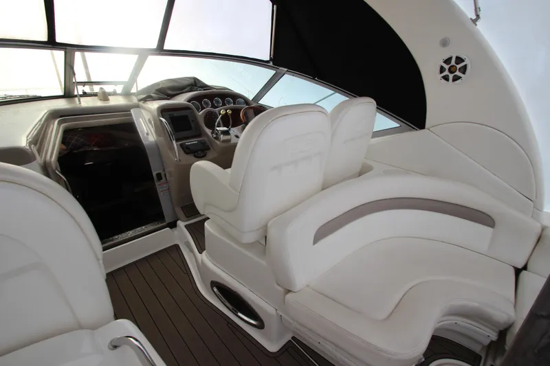 Slide: The Image of 2005 Sea Ray 340 Sundancer cockpit with white seating and modern dashboard. - 36