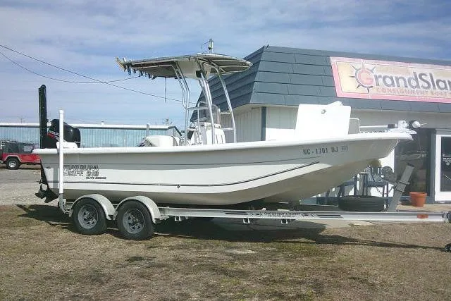 The Image of 2008 Carolina Skiff 218 DLV Elite boat on trailer outside dealership. - 1