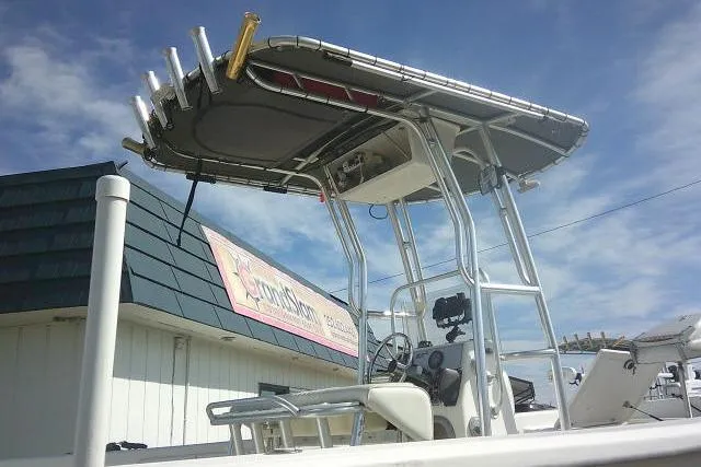 Slide: The Image of 2008 Carolina Skiff 218 DLV Elite boat with T-top and fishing rod holders. - 14