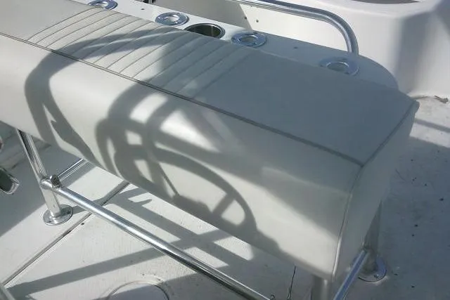 Slide: The Image of 2008 Carolina Skiff 218 DLV Elite boat seat with metal frame and cup holders. - 18