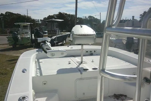 Slide: The Image of 2008 Carolina Skiff 218 DLV Elite boat, docked with visible seating and equipment. - 27