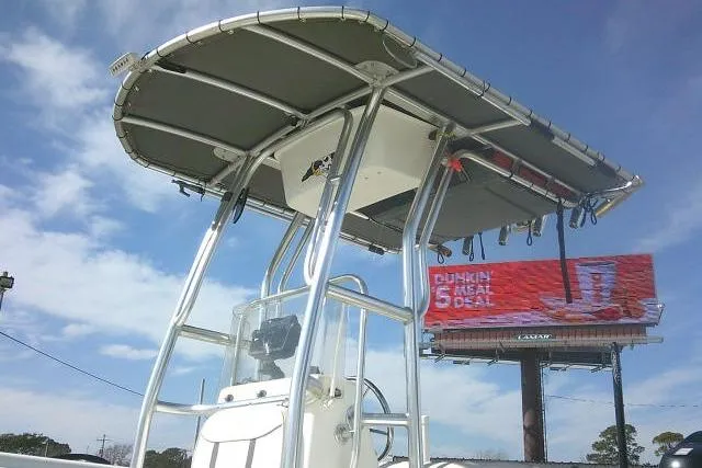 Slide: The Image of 2008 Carolina Skiff 218 DLV Elite boat with T-top against a clear sky. - 6