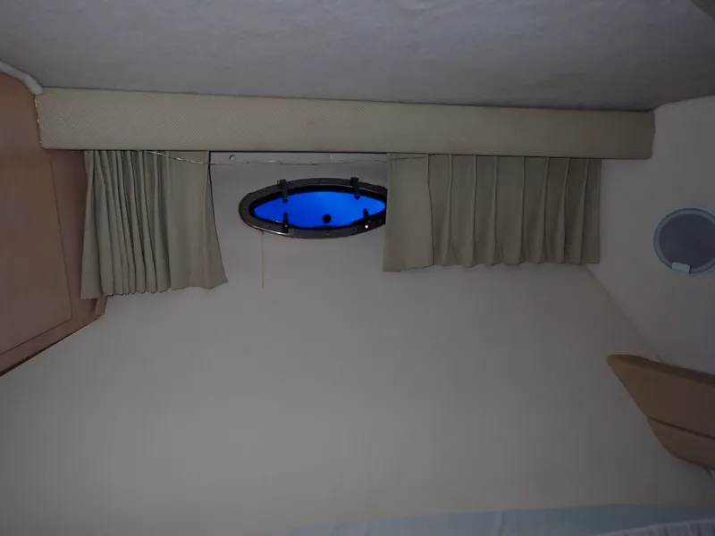 Slide: The Image of Interior of a 1997 Carver Voyager with porthole and curtains. - 10