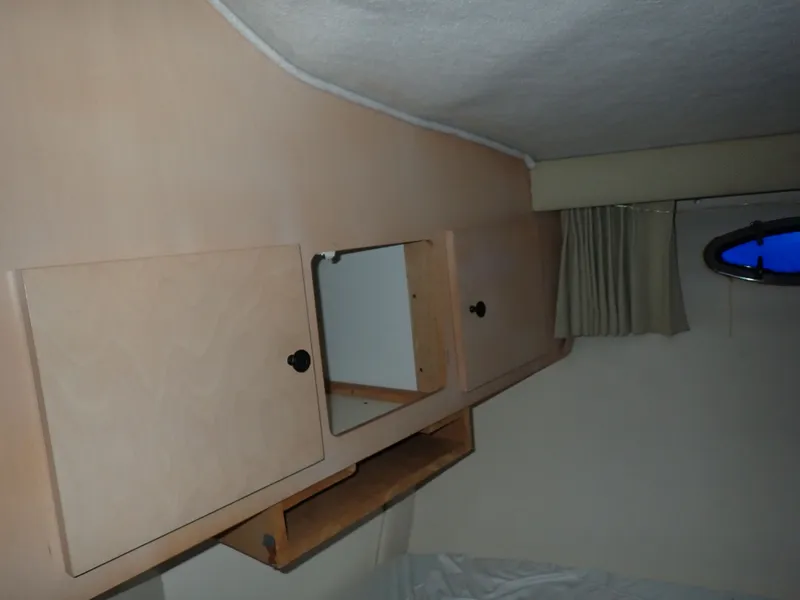 Slide: The Image of Interior of a 1997 Carver Voyager with wooden cabinets. - 11