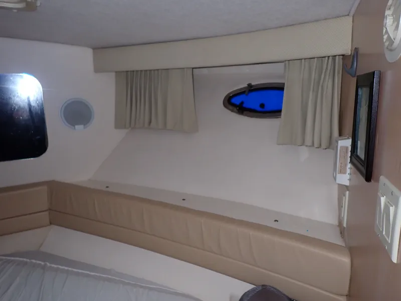 Slide: The Image of Interior of a 1997 Carver Voyager yacht with upholstery and porthole. - 9