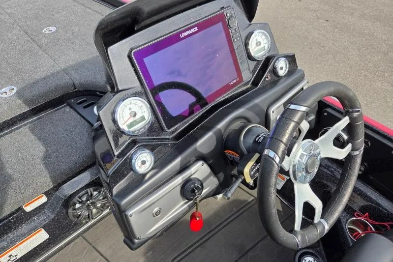 Slide: The Image of 2022 Nitro Z21 XL boat dashboard with Lowrance display and steering wheel. - 12