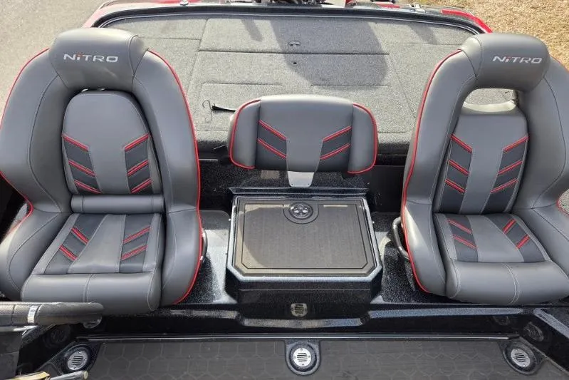 Slide: The Image of 2022 Nitro Z21 XL boat seats with red accents and center console. - 15