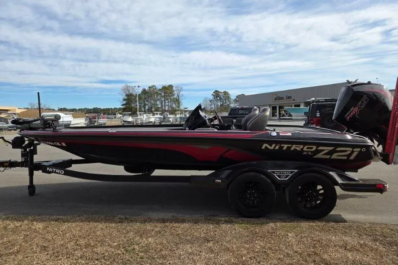 Slide: The Image of 2022 Nitro Z21 XL bass boat on trailer, parked outdoors. - 6