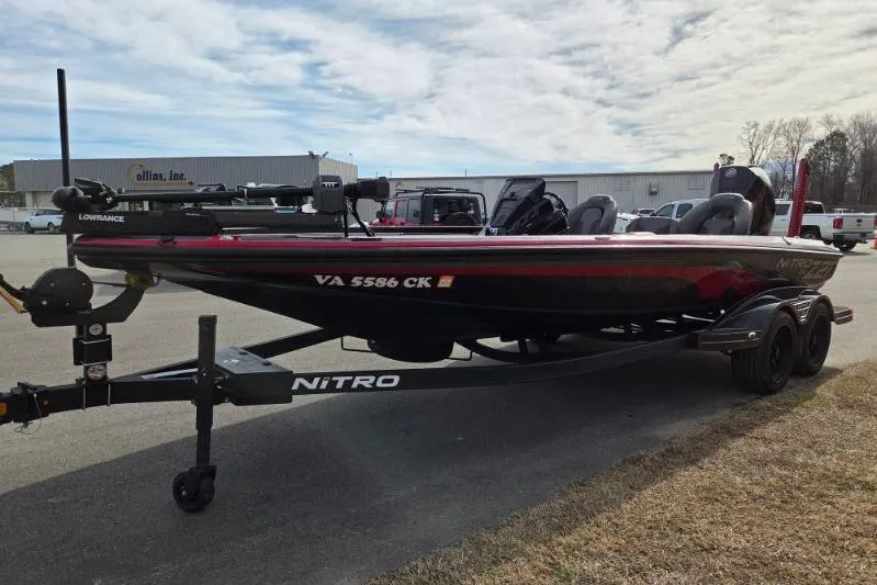 Slide: The Image of 2022 Nitro Z21 XL boat on trailer, parked outdoors under cloudy sky. - 7