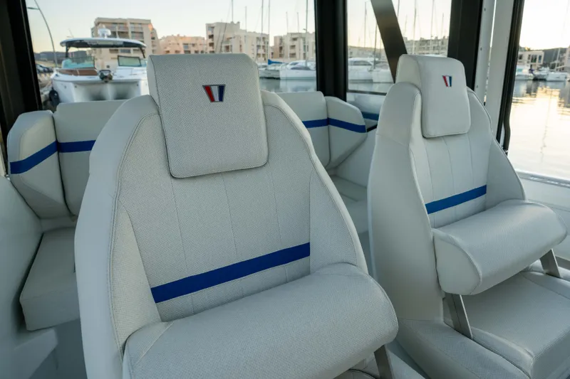Slide: The Image of Interior seating of 2026 Wellcraft 28 Explorer boat, featuring modern design and blue accents. - 10
