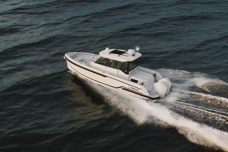 Slide: The Image of 2026 Wellcraft 28 Explorer cruising on open water, showcasing sleek design and performance. - 16