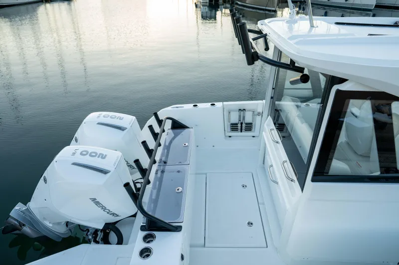 Slide: The Image of 2026 Wellcraft 28 Explorer boat with dual Mercury outboard engines docked at marina. - 17
