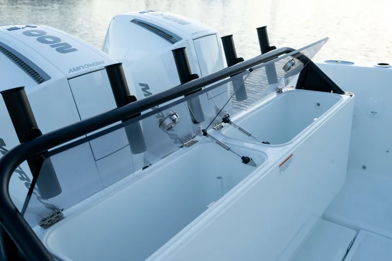 Slide: The Image of 2026 Wellcraft 28 Explorer boat with Mercury engines and open storage compartment. - 18