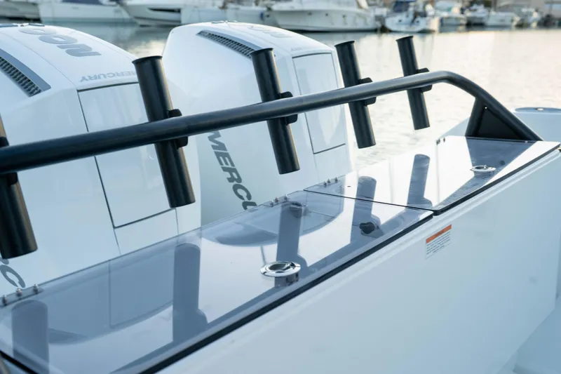 Slide: The Image of 2026 Wellcraft 28 Explorer boat with Mercury engines at a marina. - 19