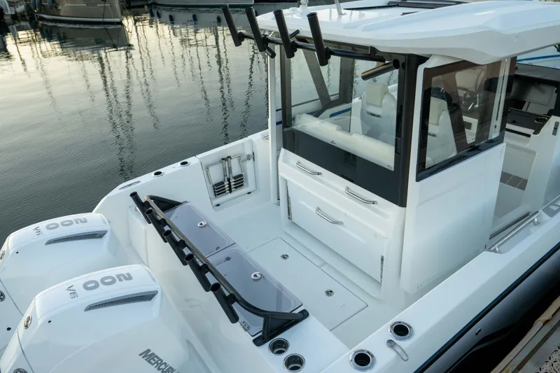 Slide: The Image of 2026 Wellcraft 28 Explorer boat with dual Mercury engines docked at marina. - 21
